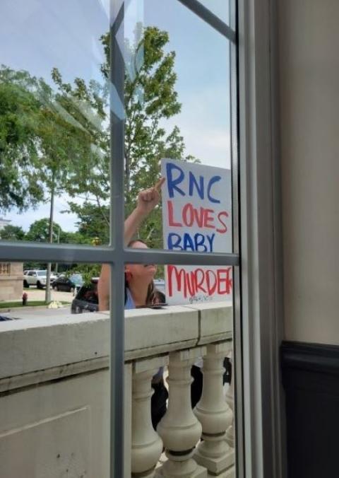 An anti-abortion protester holds up a sign outside a July 16 event sponsored by Georgetown University as part of the Republican National Convention in Milwaukee. An anti-abortion protester holds up a sign outside a July 16 event sponsored by Georgetown University as part of the Republican National Convention in Milwaukee.